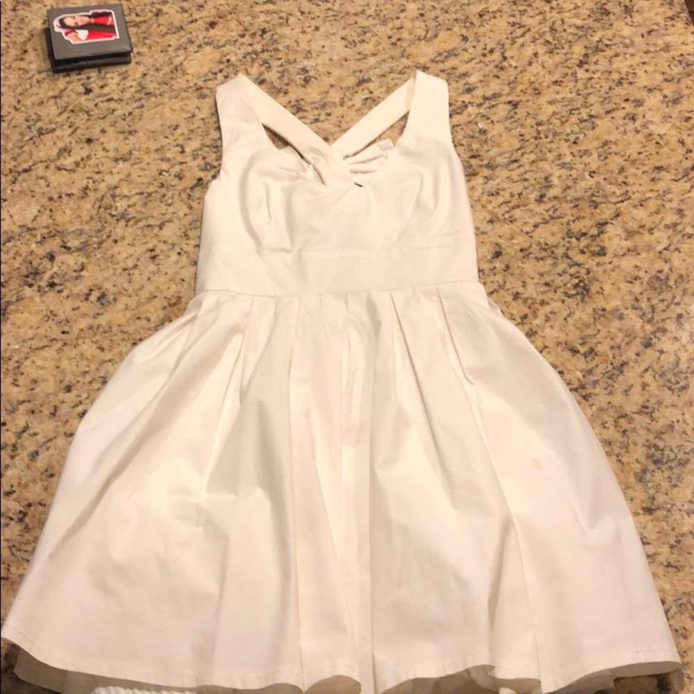 White flare dress w/ bow tie on criss cross back
